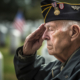 American Senior War Veteran saluting his fallen comrades