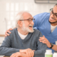 Caring healthcare worker embracing an elderly person