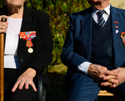 Front view of two veteran spouses sitting together outside