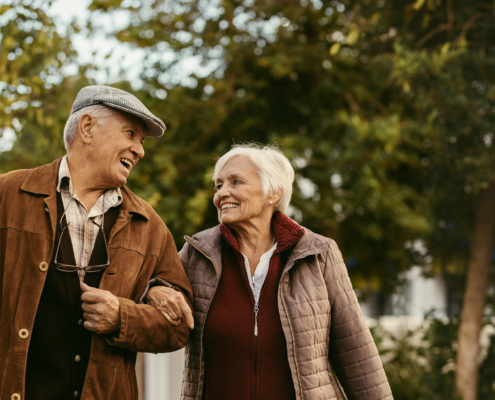 Loving senior couple enjoy a walk together on a winter day